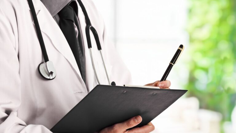 Doctor discreetly holding a consultation paper for erectile dysfunction treatment options